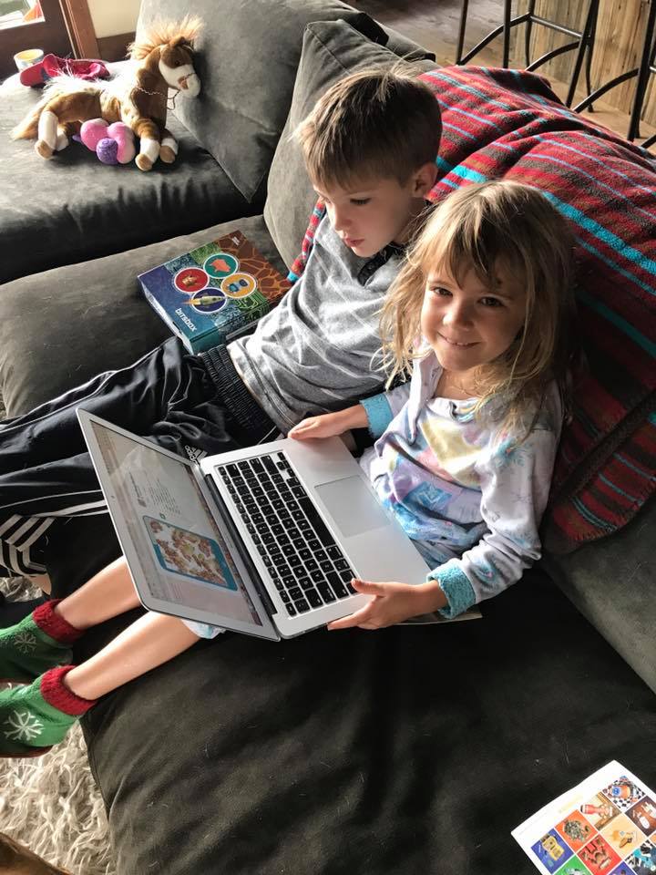 Parent helping child with coding